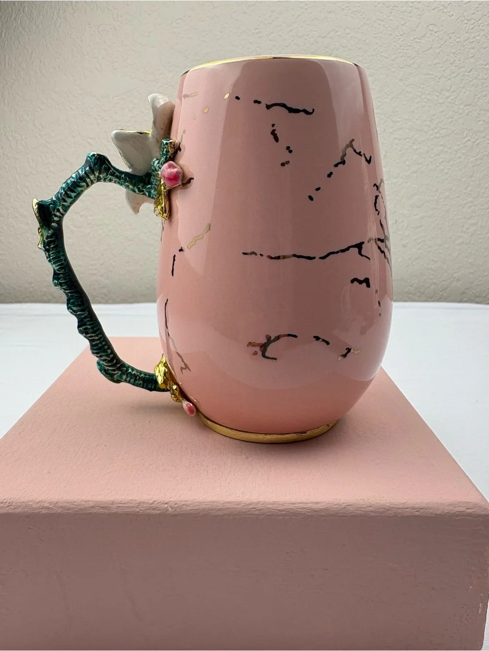 Pink ceramic enamel mug decorated with a 3D floral, rhinestones, and gold trim.